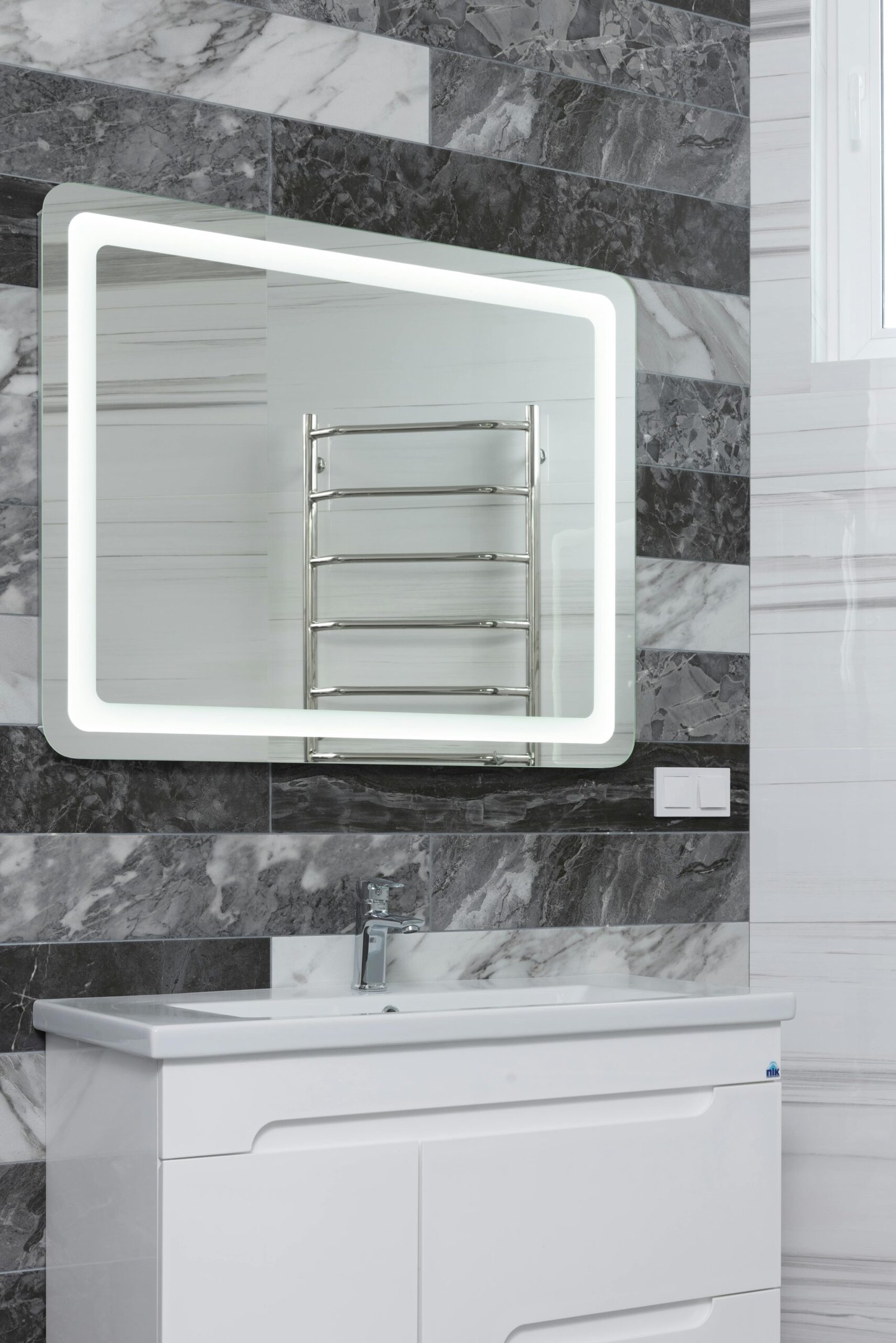 Contemporary bathroom with stainless steel tap and washstand under mirror reflecting metal rack in house